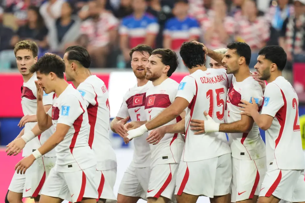 Turkey’s Orkun Kokcu, center, celebrates scoring his side’s second goal...