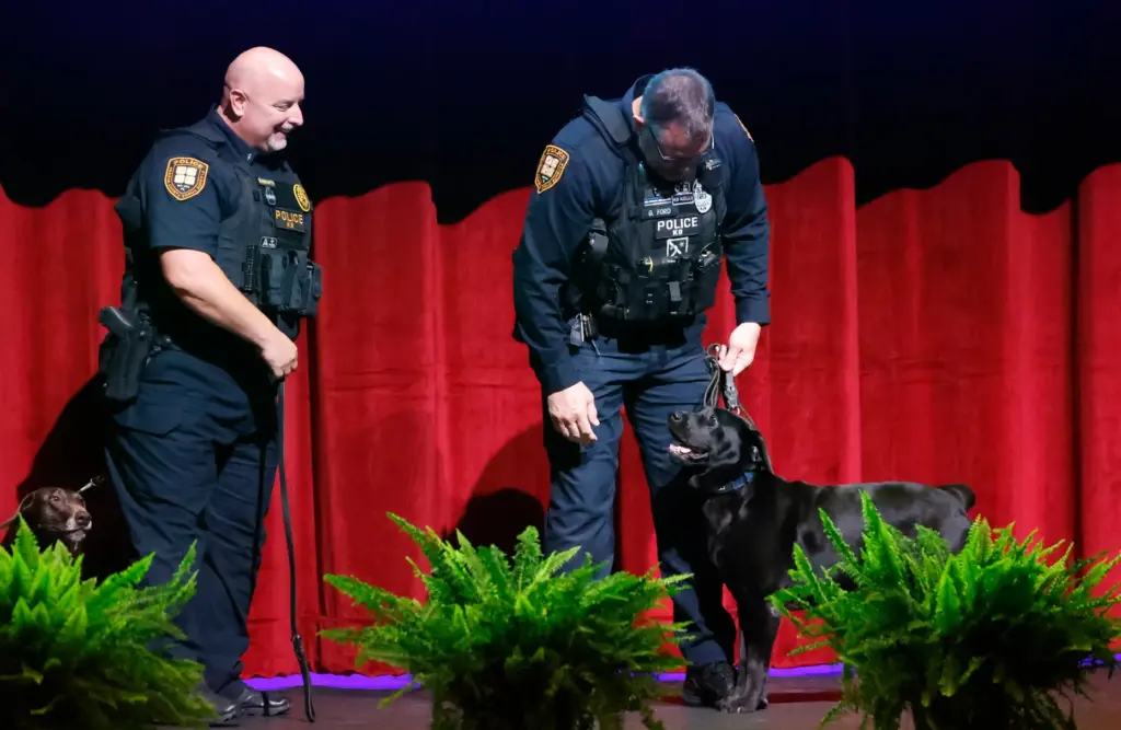 OCPS Officer Brian Howarth with K-9 Coco, on left, and...