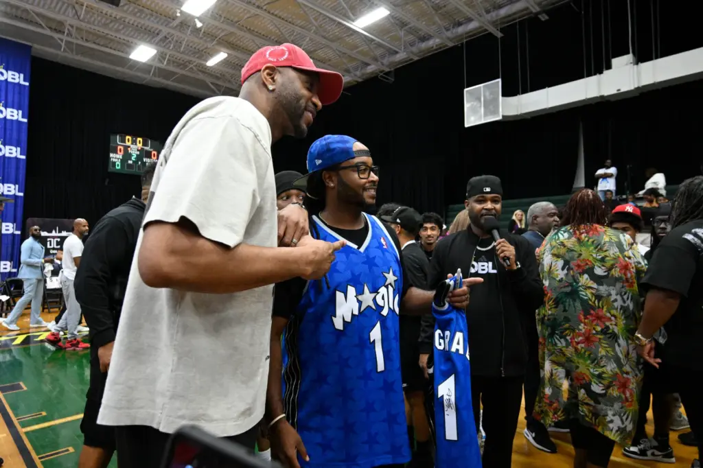 Owner Tracy McGrady, left, poses with a spectator after a...