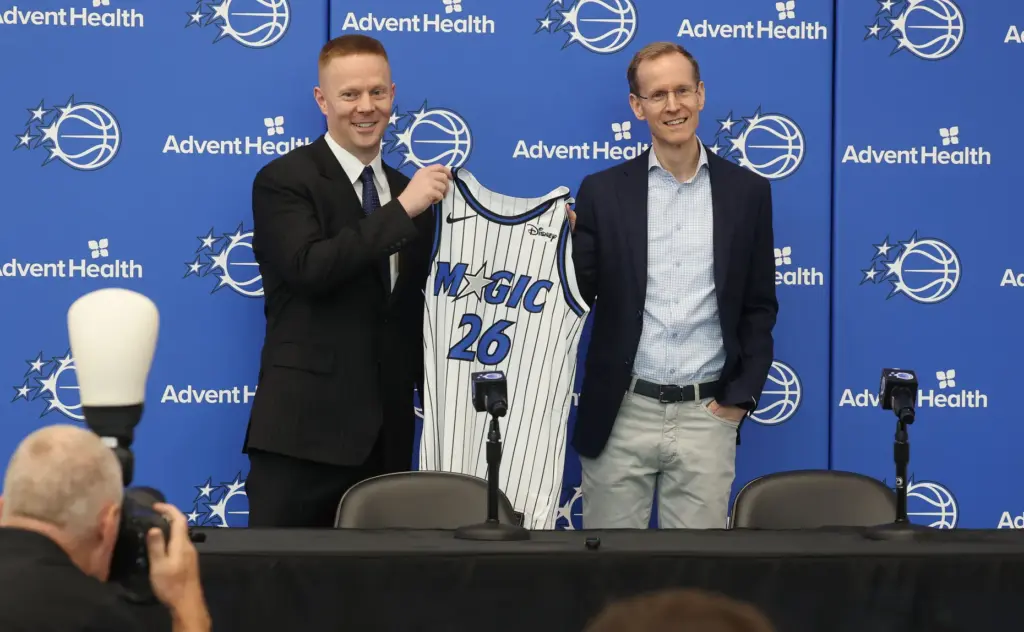 New Orlando Magic head coach Sean Sweeney, left, and Magic...