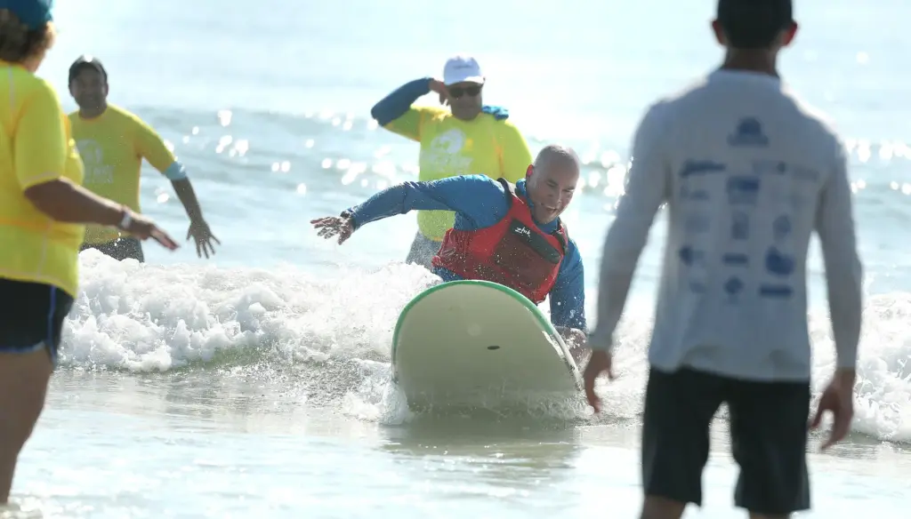 A wounded veteran enjoys the surf at New Smyrna Beach...