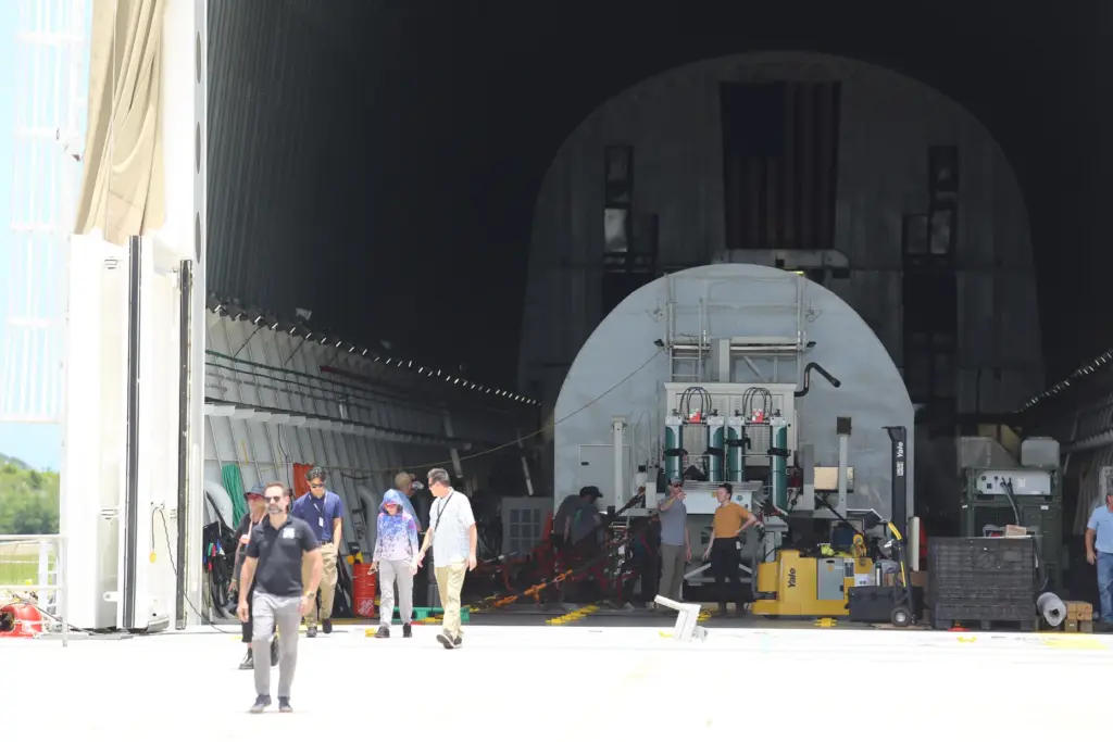 Lucas Paganini, program executive in NASAâs Astrophysics Division, walks out...