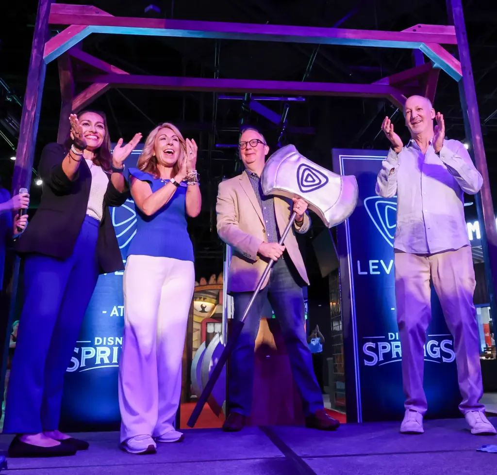 Level99 and Disney executives cheer as CEO Matt DuPlessie, center,...