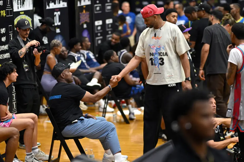 Tracy McGrady, right, chats with Team Miami owner Tim Hardaway...