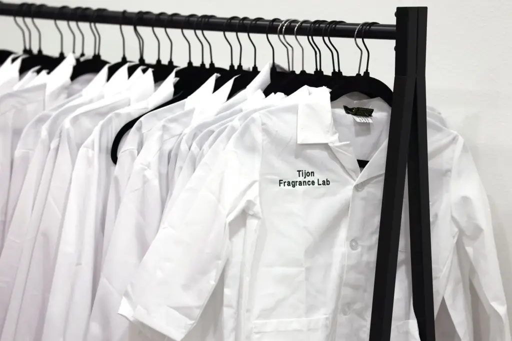 Lab coats hang on a rack during a grand opening...