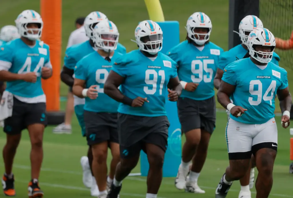 Miami Dolphins defensive players take the field during mandatory minicamp...
