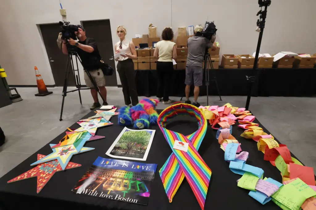 Journalists film artifacts and items collected after the PULSE tragedy....