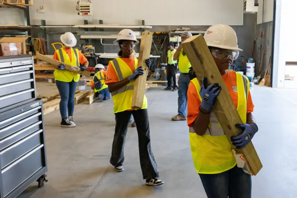 Campers get supplies to begin building a planter box, one...