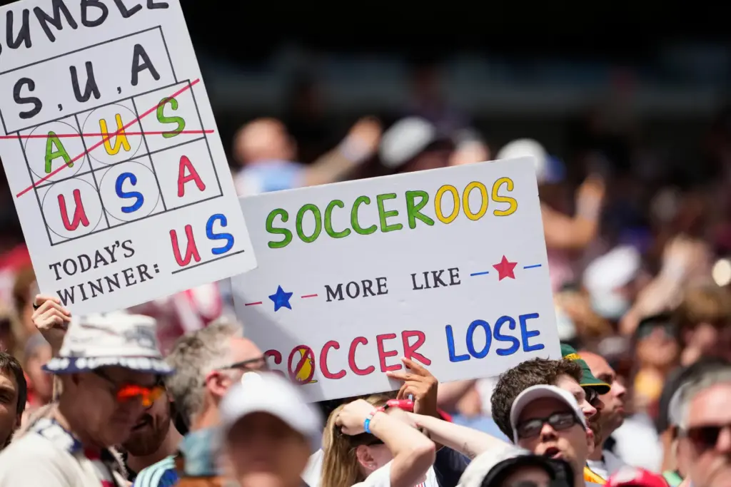 United States fans hold signs on the stand during the...