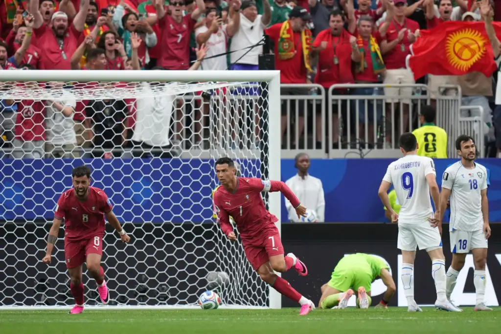 Portugal’s Cristiano Ronaldo (7) celebrates after scoring the opening goal...