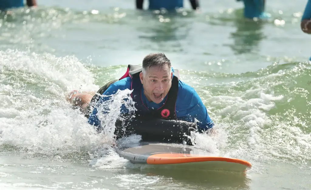 Army veteran Jeff Palenske enjoys riding a wave at New...