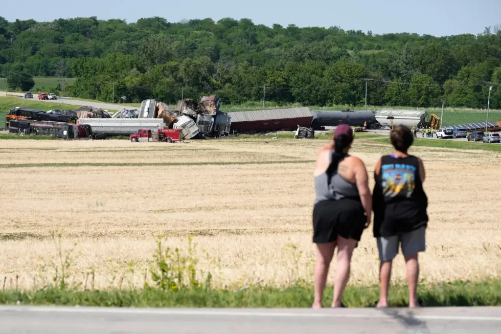 Spectators view damage after a train derailed on Wednesday, June...