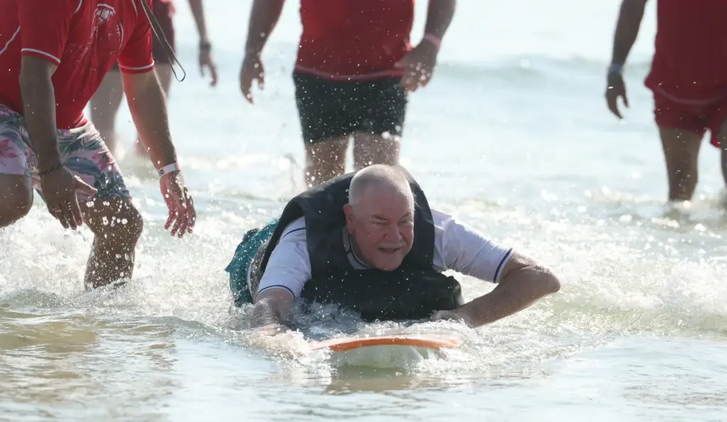 Navy veteran Rick Rettinger surfs at New Smyrna Beach on...