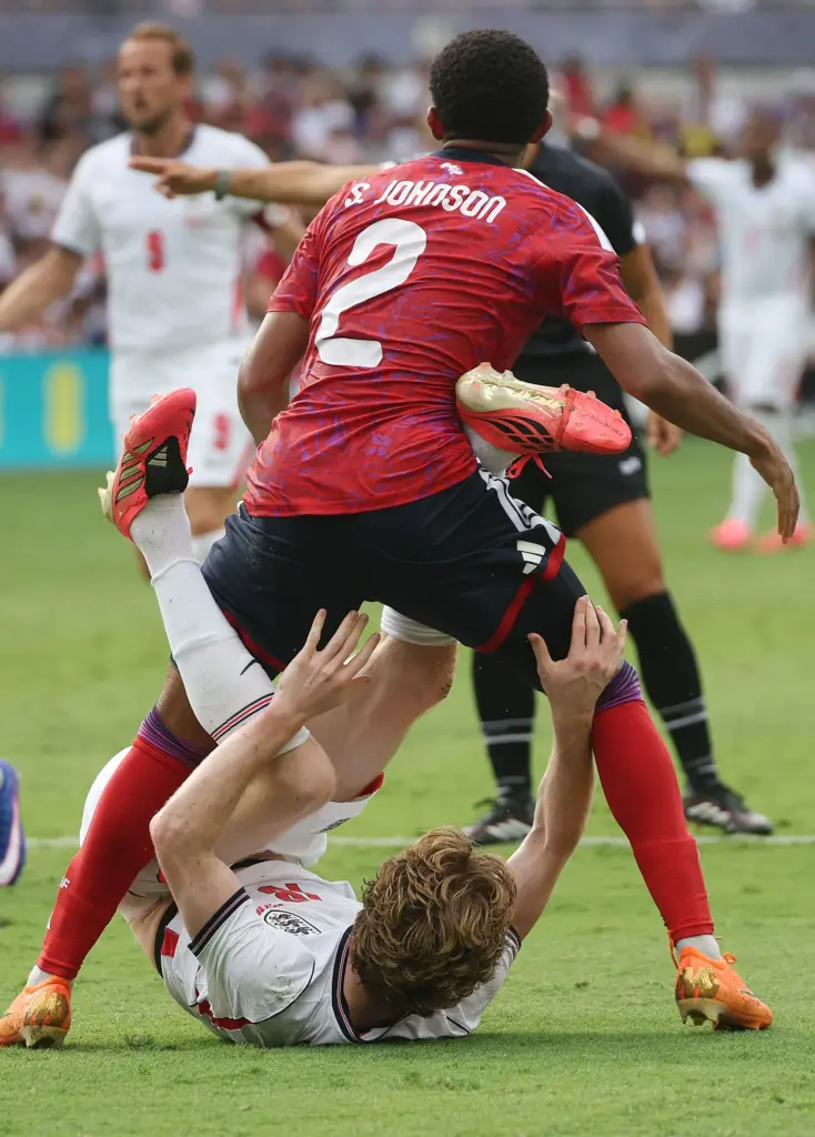England player Anthony Gordon (bottom) struggles under Costa Rica player...