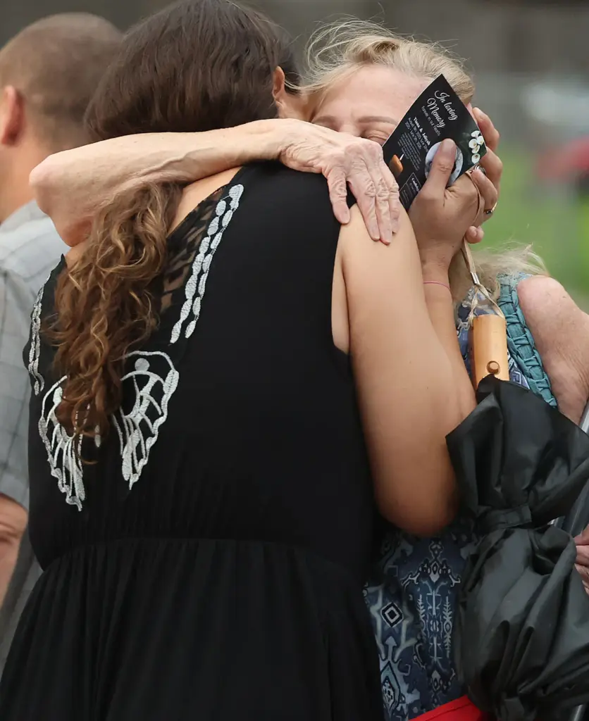 Mourners hugduring a community vigil for 2-year-old Tiana Rae Watts...