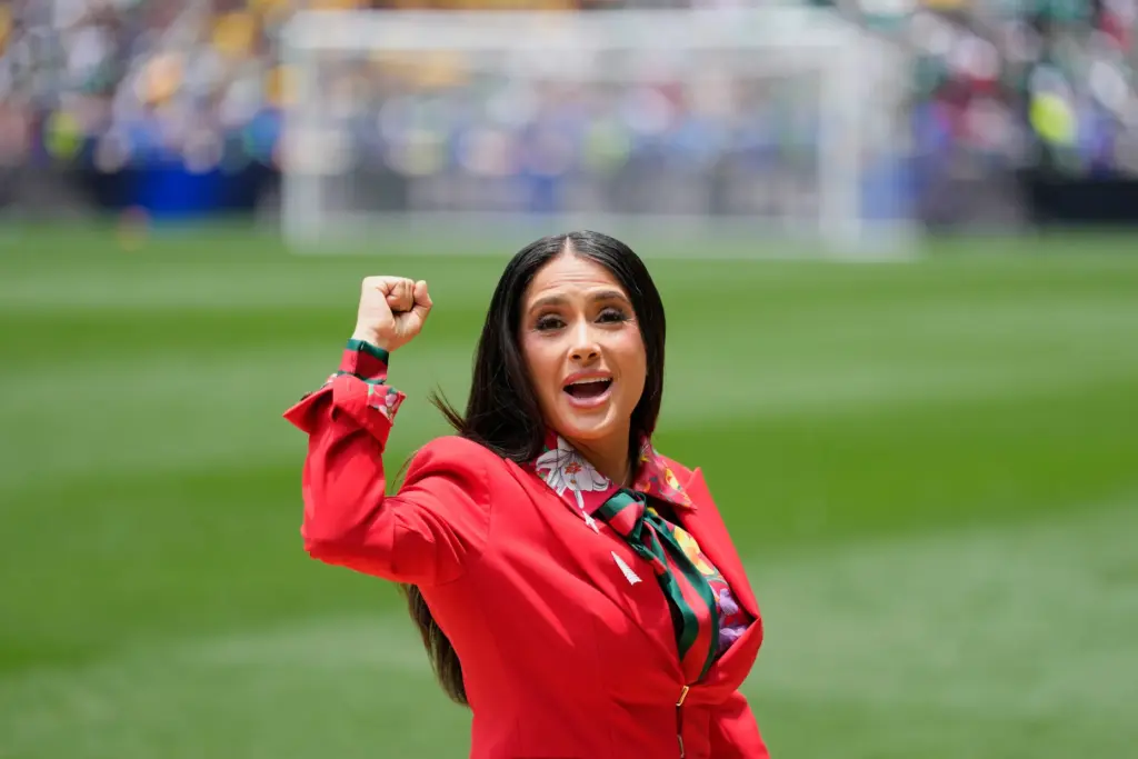 Mexican-American actress Salma Hayek gestures on the pitch before the...