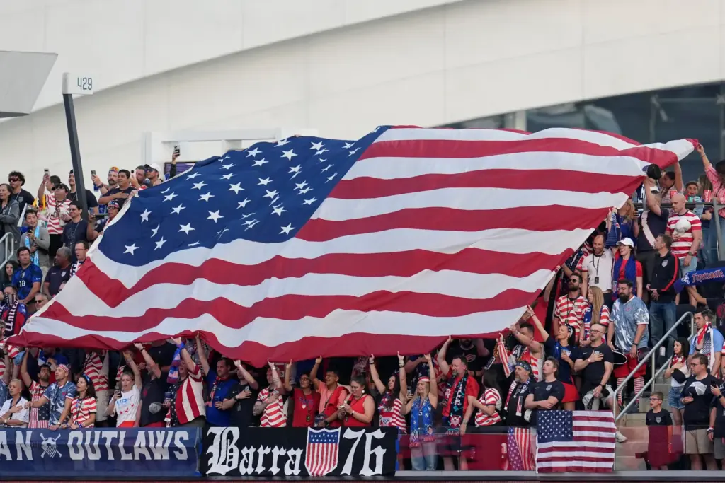 United States fans stand for their national anthem prior to...