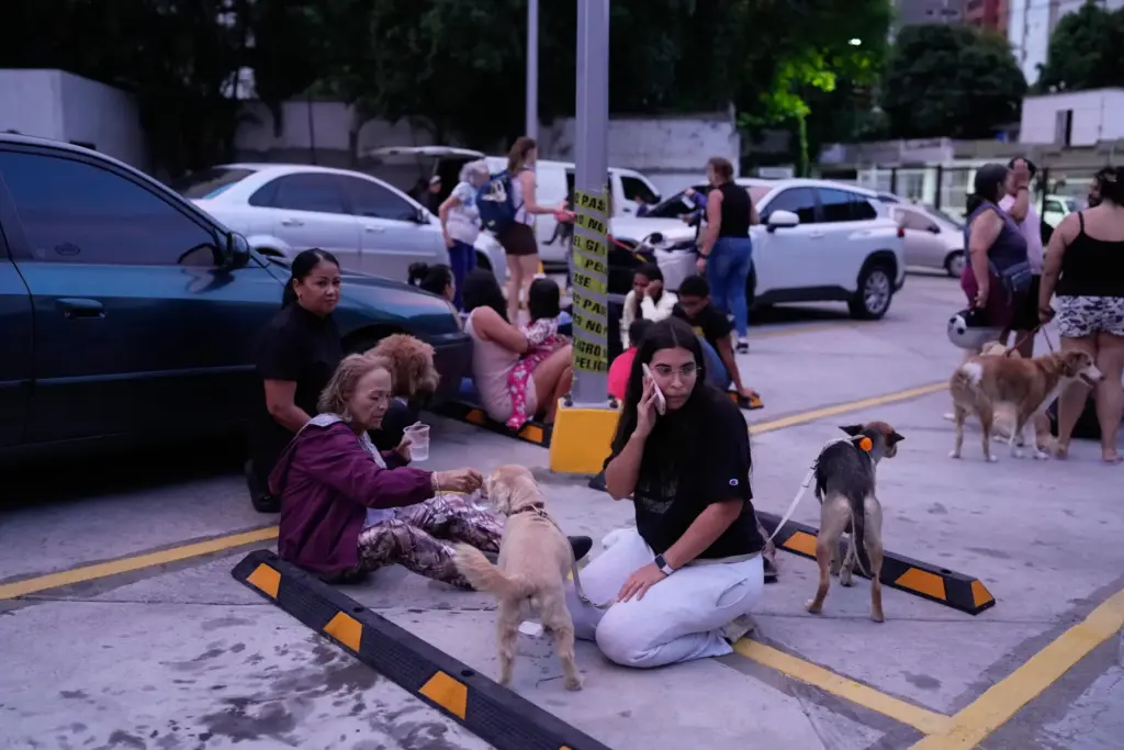 People stay outside their homes after an earthquake in Caracas, Venezuela.