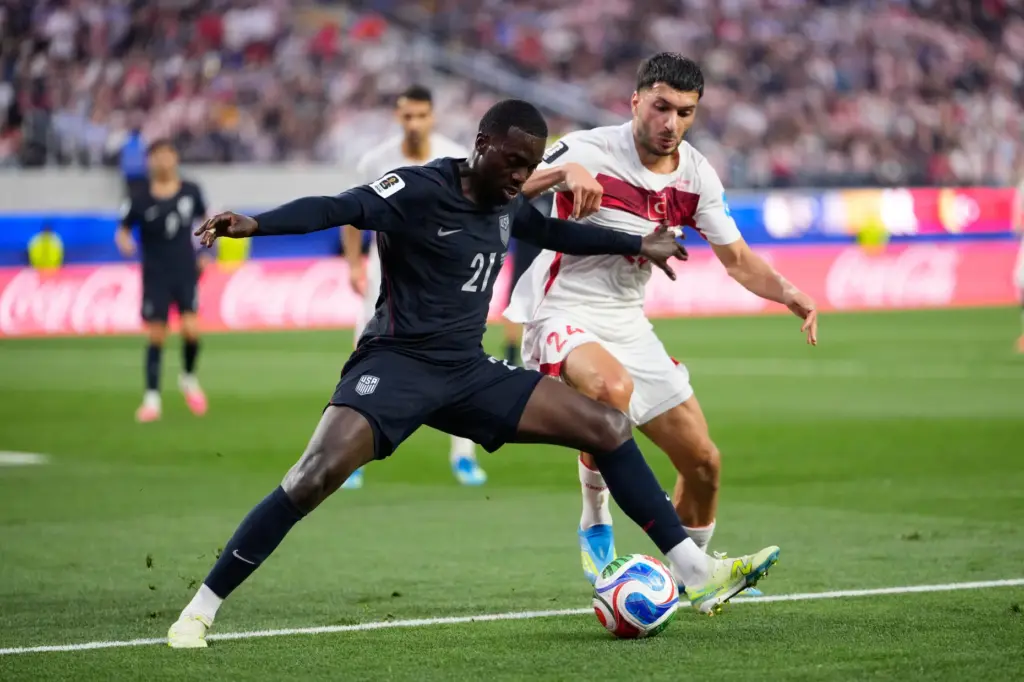 United States’ Timothy Weah (21) and Turkey’s Oguz Aydin battle...