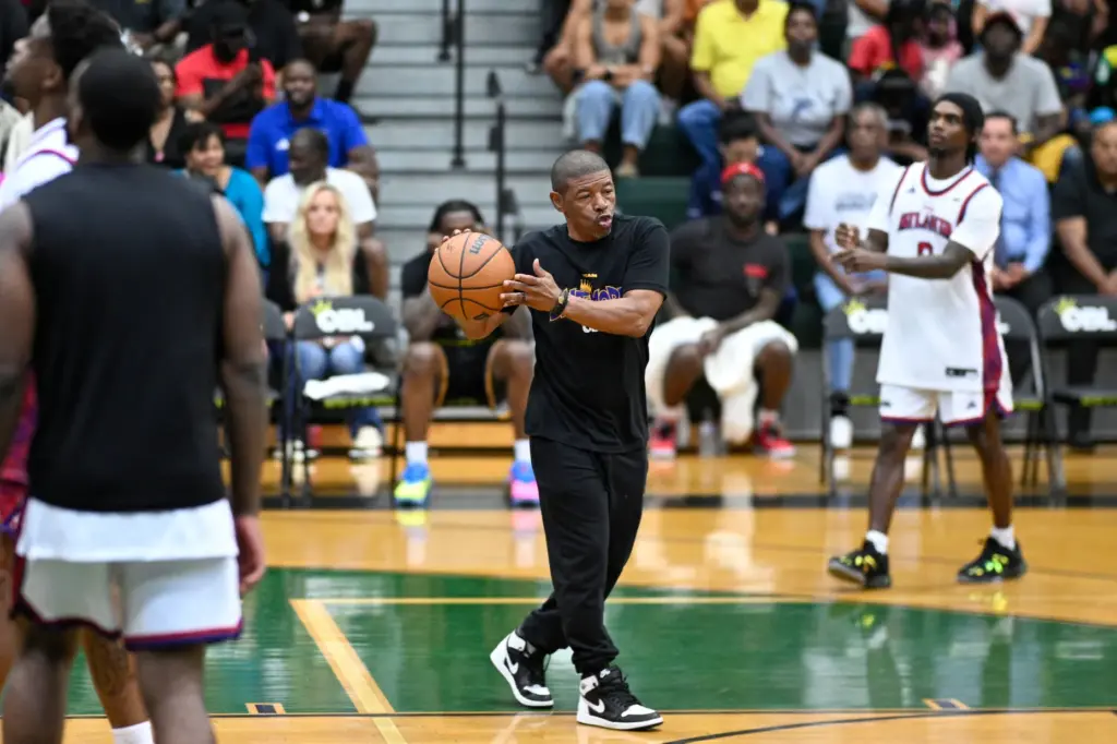 Baltimore owner Mugsy Bogues, center, helps his team warm up...