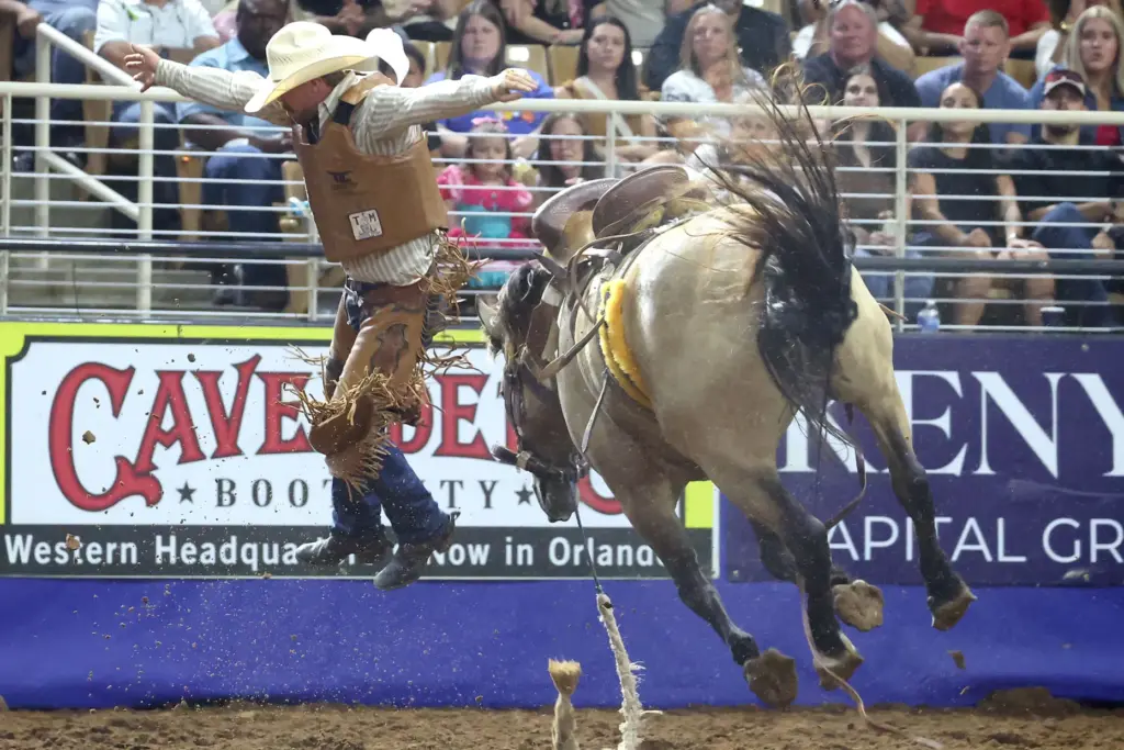 Hayden Hall leaps off a bucking bronc after his ride...