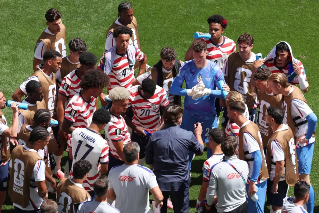 United States head coach Mauricio Pochettino speaks to his players during a hydration break.