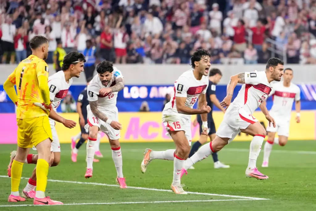 Turkey’s Kaan Ayhan, right, celebrates scoring his side’s third goal...