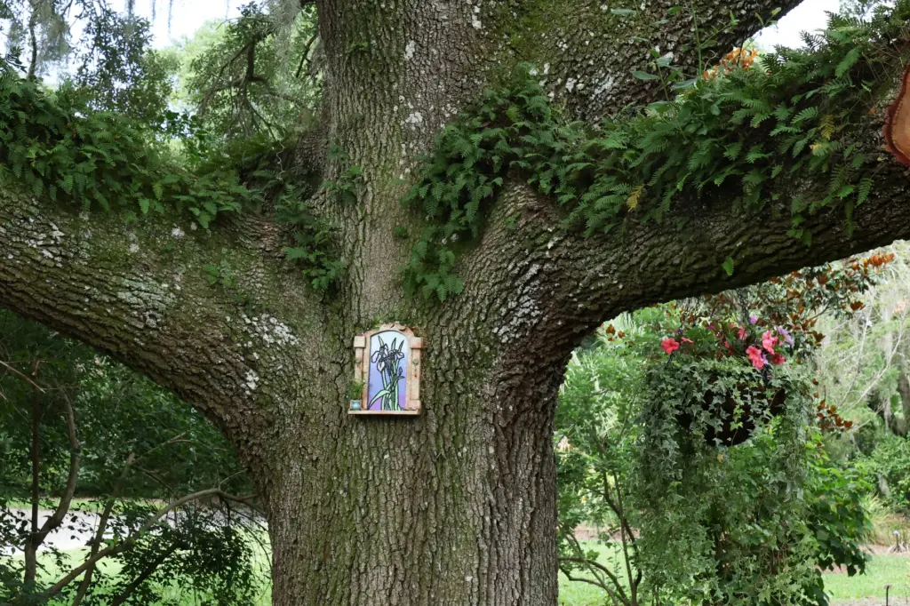 Flower fairy Irisâs door among the plants and trees at...