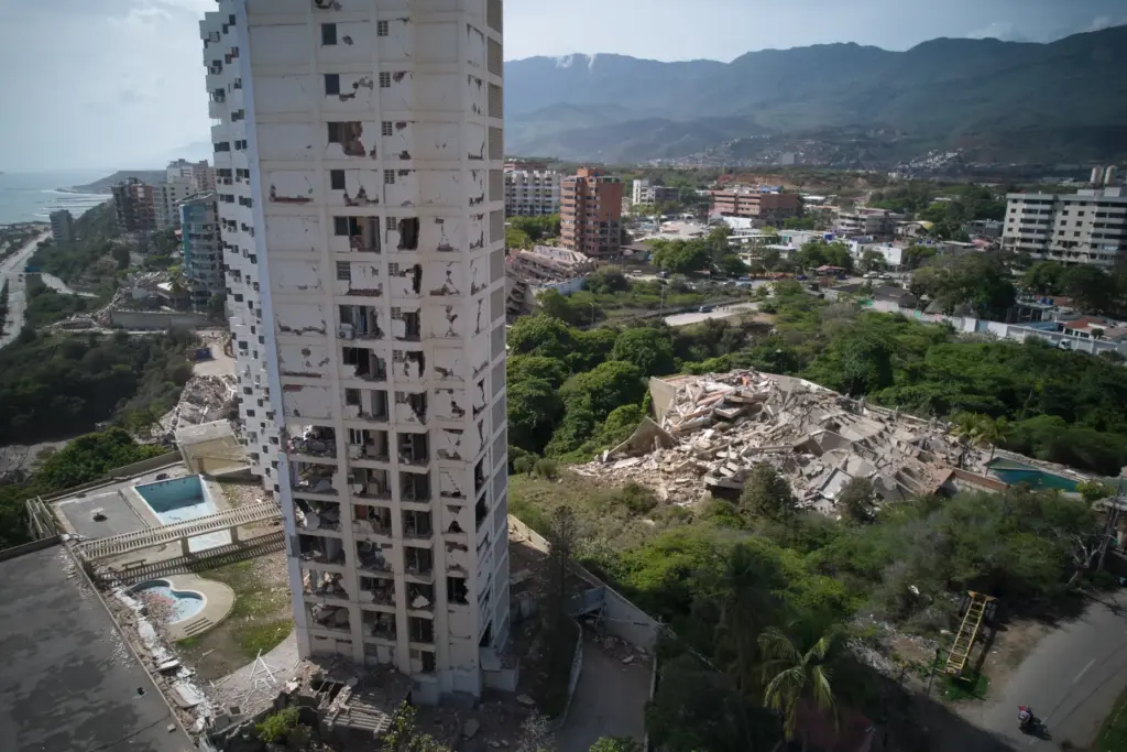 Damaged buildings stand a day after earthquakes struck La Guaira,...