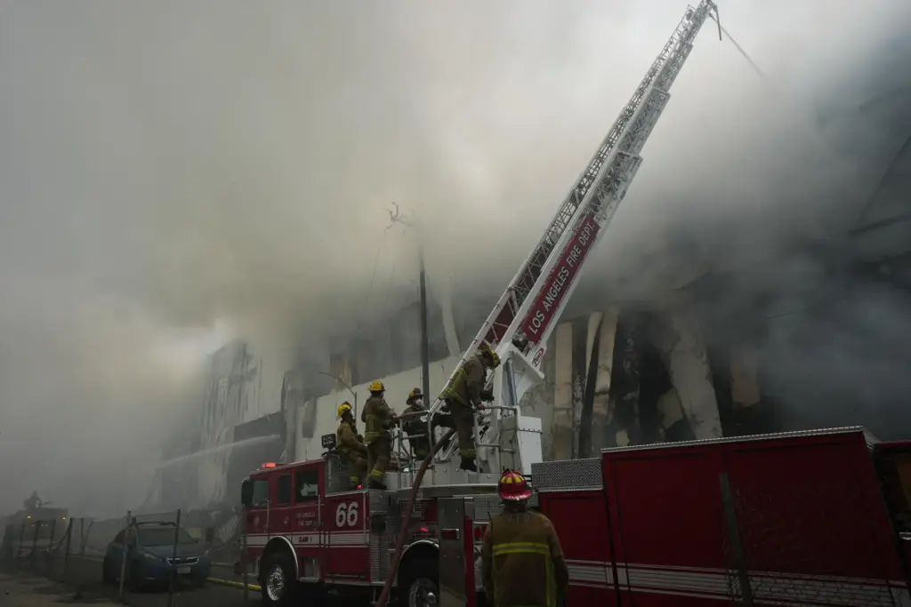 Firefighters fight a warehouse fire in the Boyle Heights neighborhood...