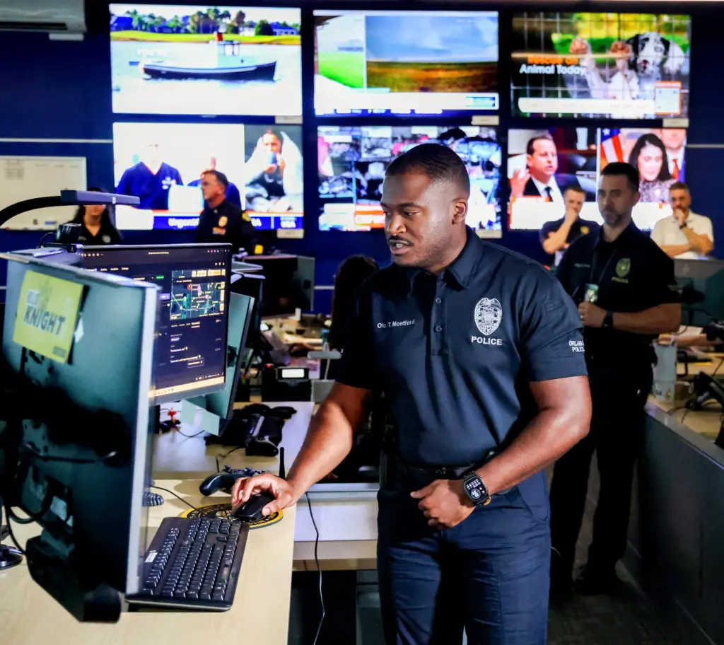 Orlando Police drone pilot Officer Todd Montford navigates from the...