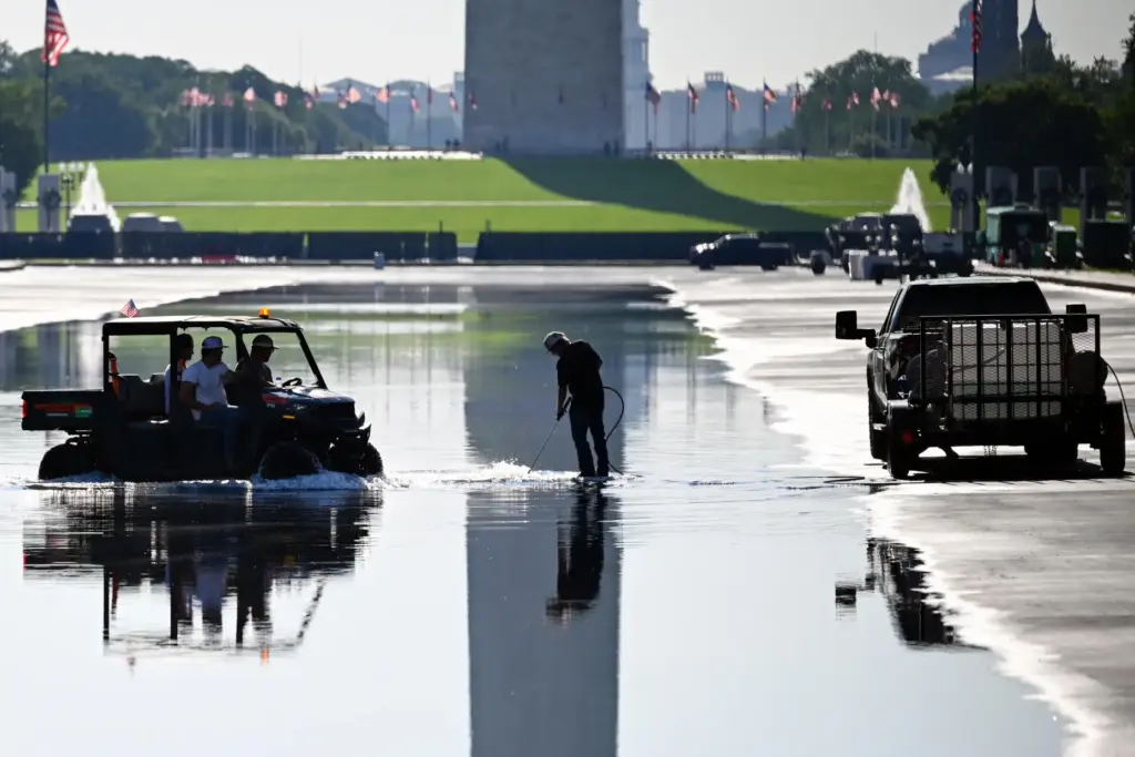 Workers concentrate on a plumbing fixture in the Lincoln Memorial...