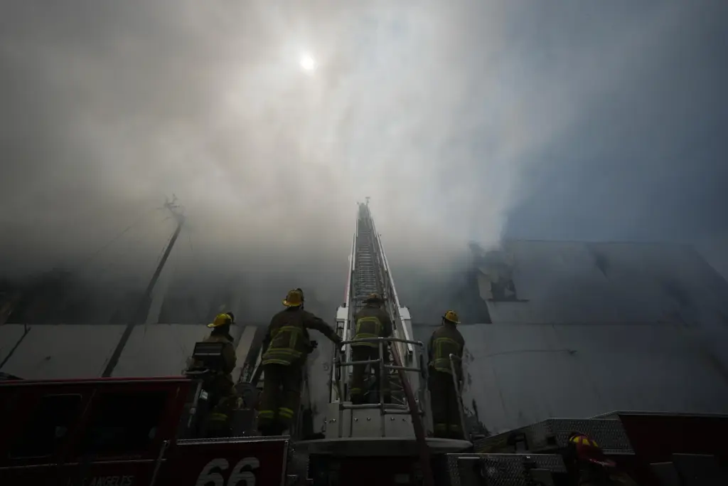 Firefighters fight a warehouse fire in the Boyle Heights neighborhood...