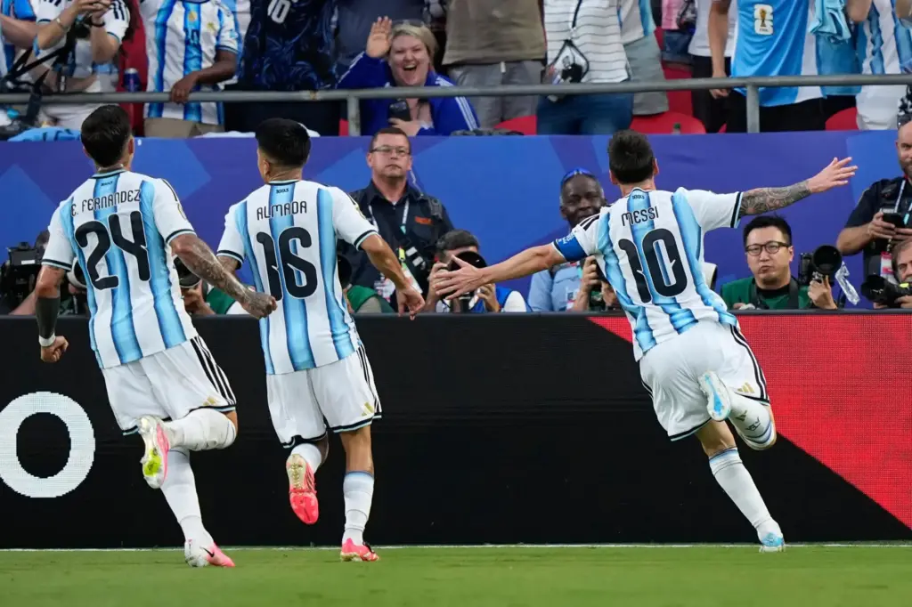 Argentina’s Lionel Messi, right, celebrates after scoring his team’s first...