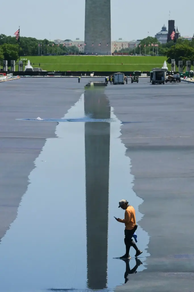 A worker walks through water as it flows into the...