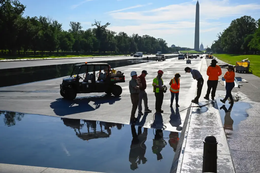 Workers refill the Lincoln Memorial Reflecting Pool after several months...