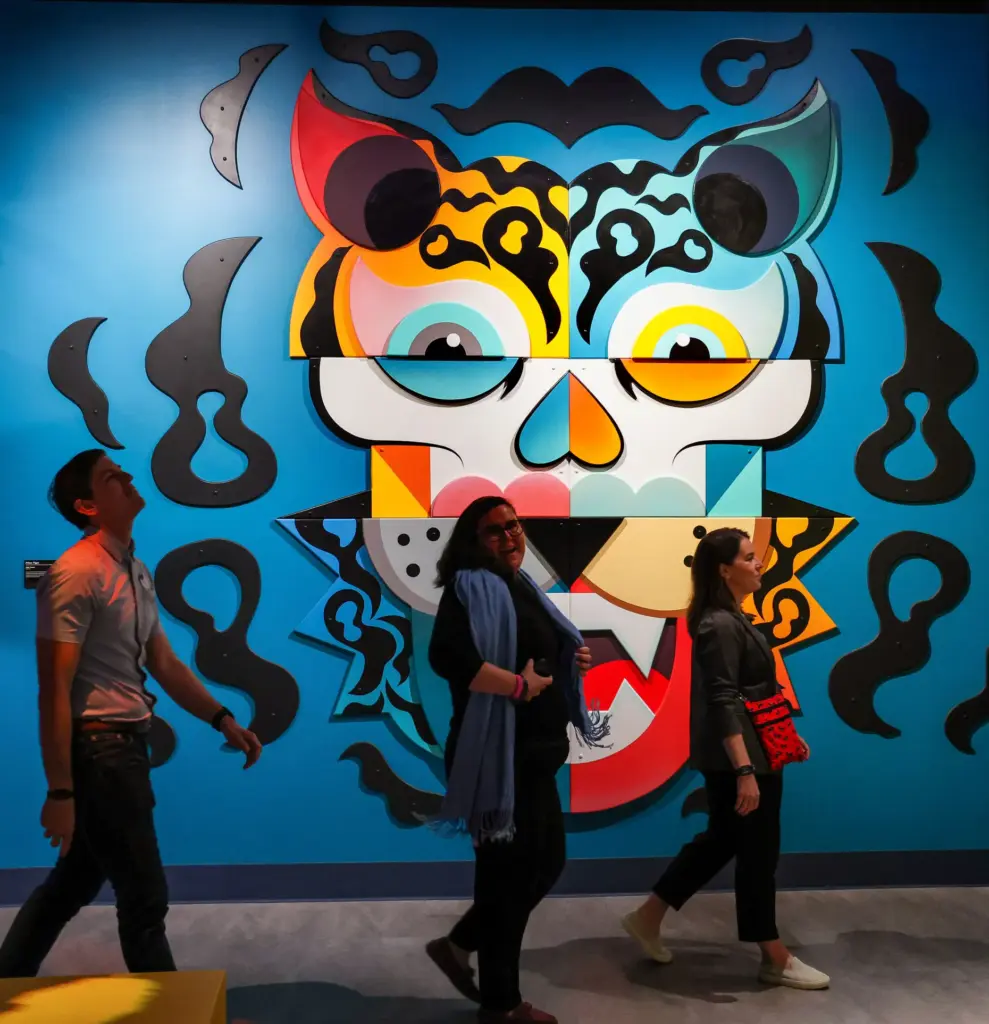 Guests walk past âPrism Tigerâ by Miami artist Alex Yanes...