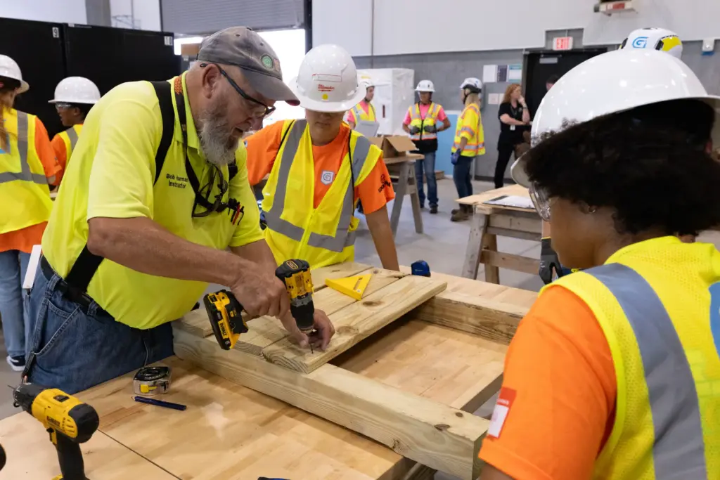 Instructor Bob Harman gives a drill demonstration for campers during...