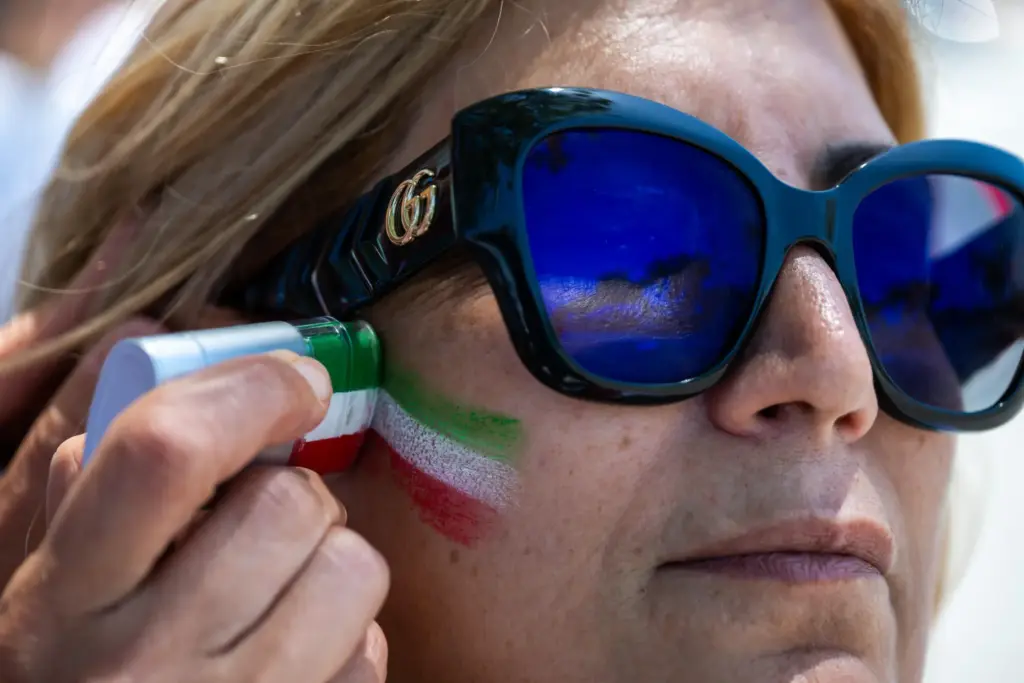 A woman has her face painted during a protest in...