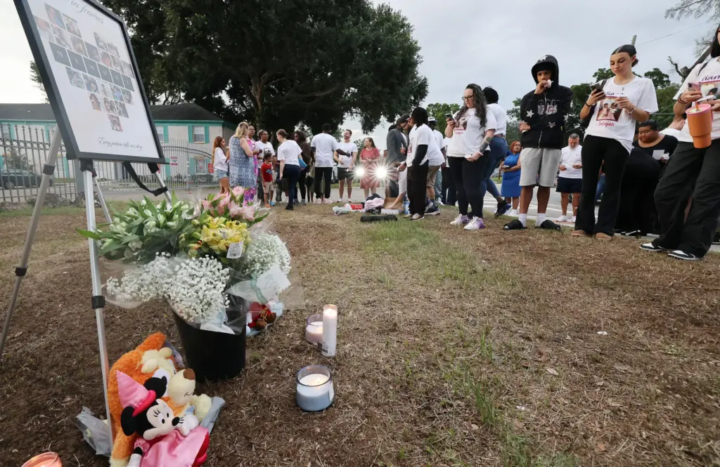 Mourners gather during a community vigil for 2-year-old Tiana Rae...