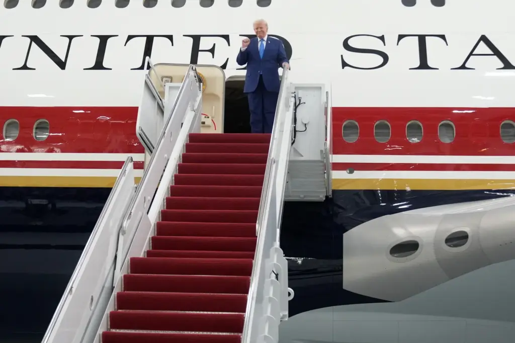 President Donald Trump exits the newly designated Air Force One...