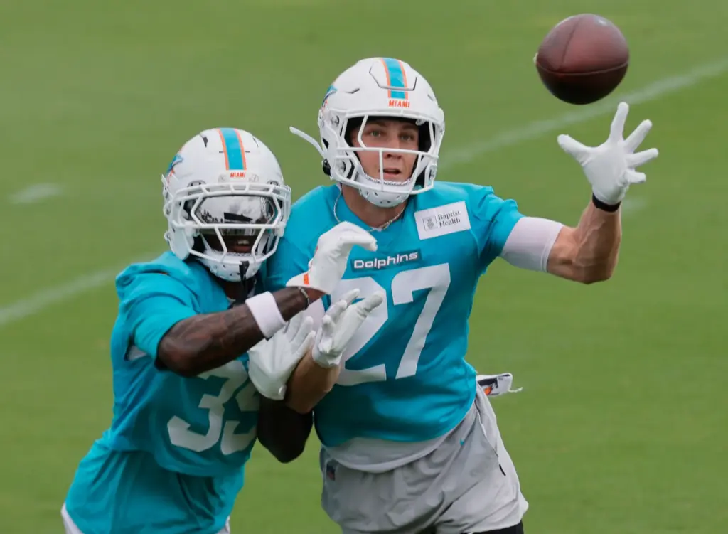 Miami Dolphins cornerbacks Miles Battle, left, and Ethan Bonner fight...