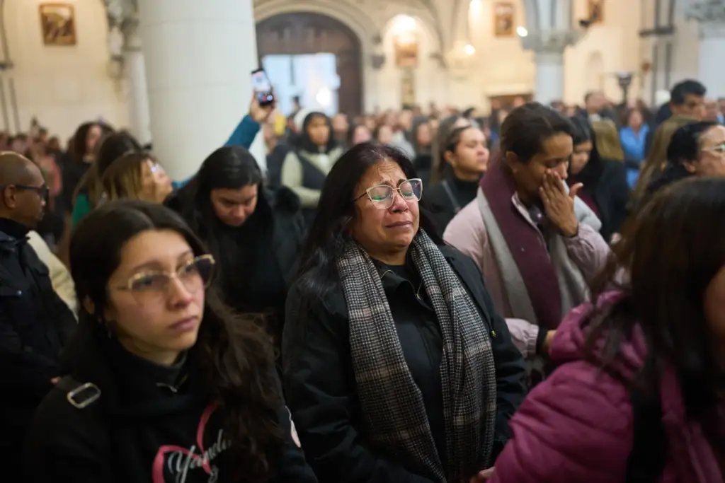 People attend a mass to honor the victims of the...