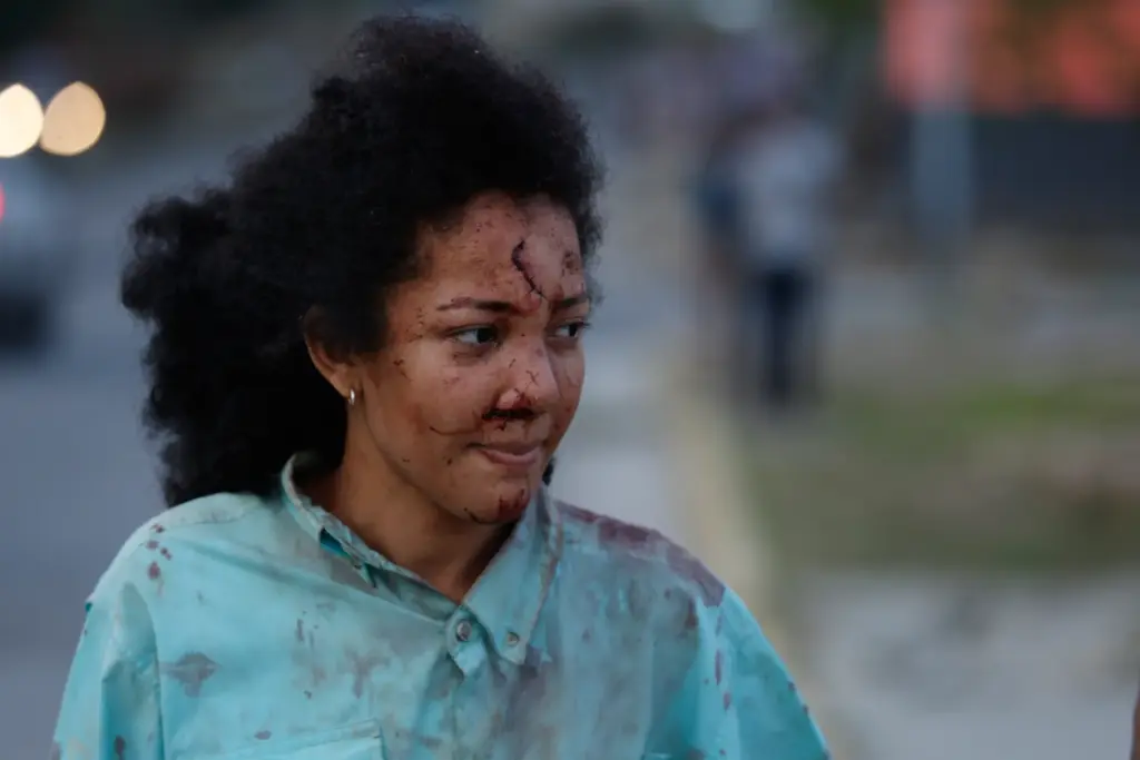 An injured woman walks in La Guaira, Venezuela, a day...