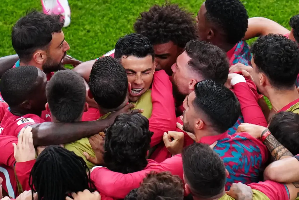 Portugal’s Cristiano Ronaldo, center, celebrates with teammates after scoring the...