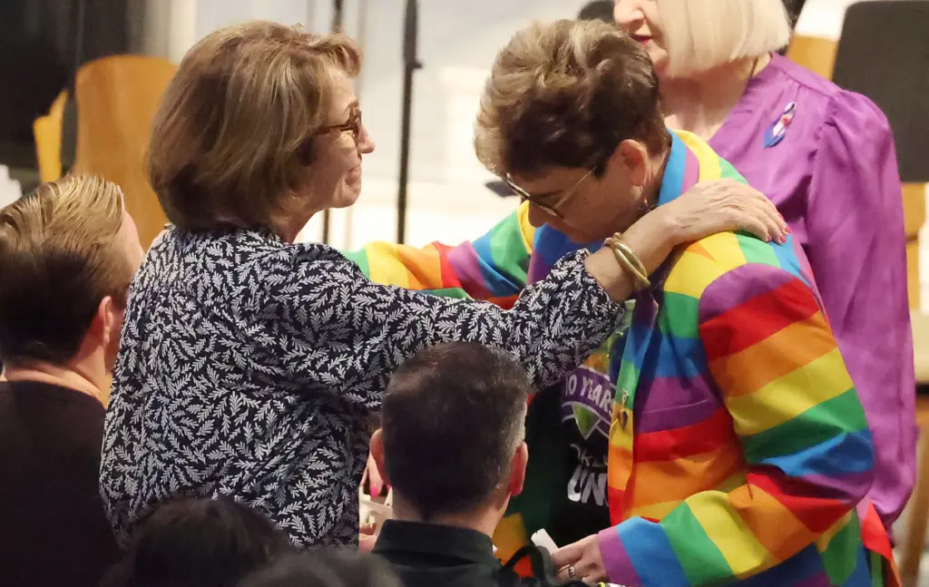 Orange County School Board Chair Teresa Jacobs (left) shares a...