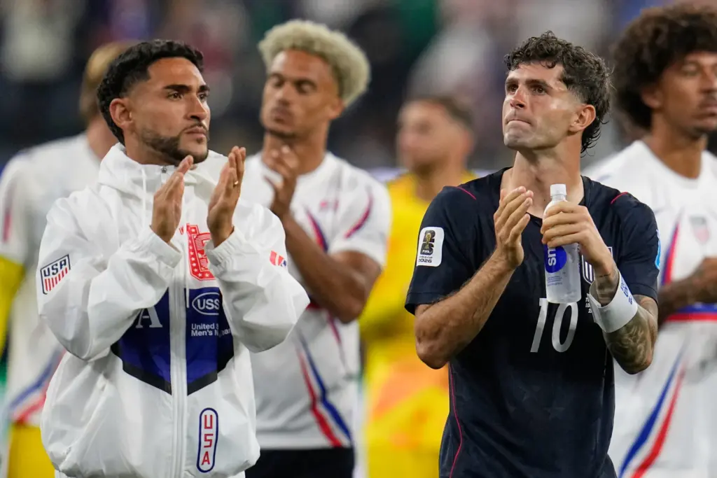 United States’ Christian Pulisic (10) and teammate Cristian Roldan, left,...