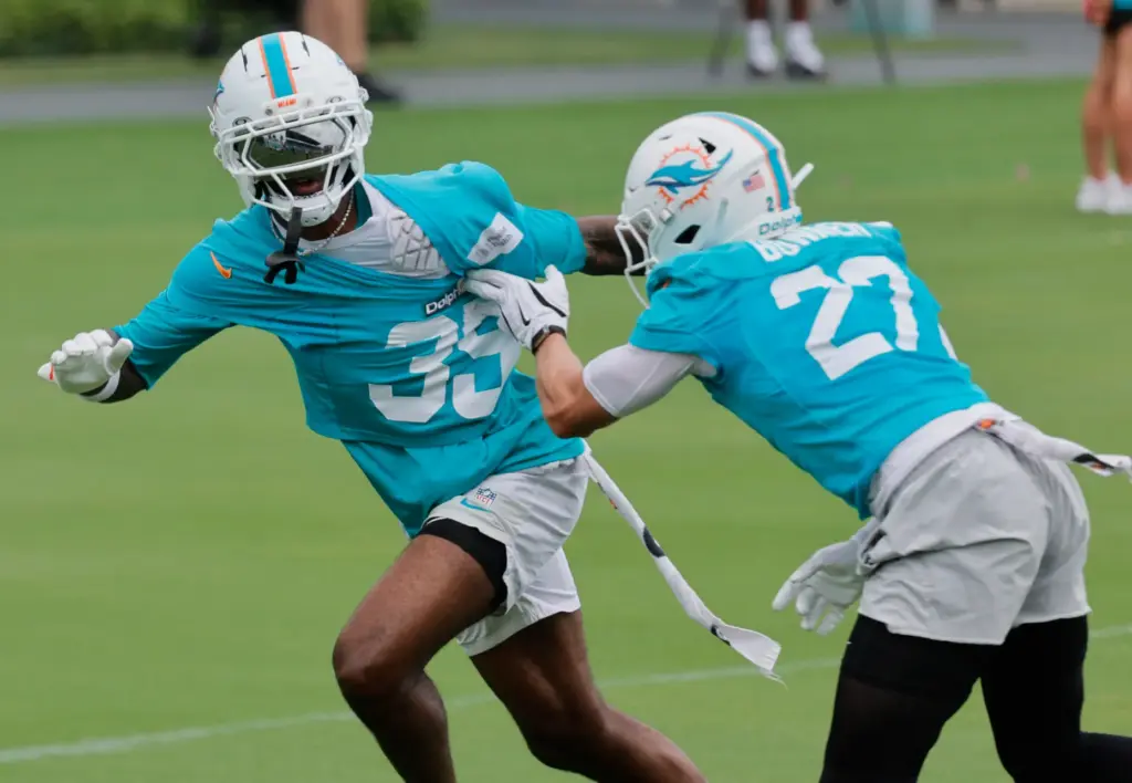 Miami Dolphins cornerbacks Miles Battle, left, and Ethan Bonner battle...