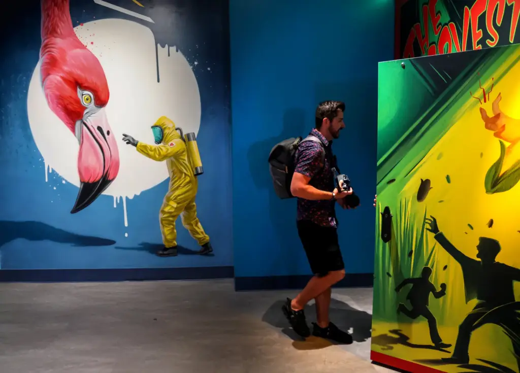 Guests walk past the artwork of Dawid Paradowski from London...