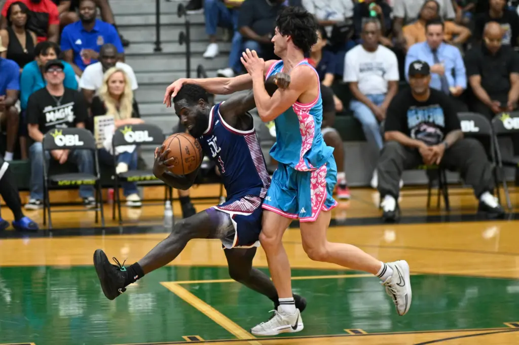 Team DCâs Kevin âUncle Skoobâ Kuteyi, left, is fouled by...